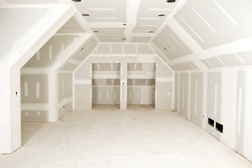 Man installing wall panel indoors